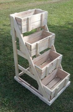 three wooden crates stacked on top of each other in the grass with an award badge above them