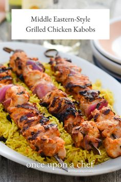 chicken and rice skewers on a white plate