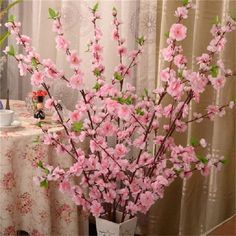 a vase filled with pink flowers on top of a table