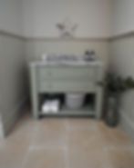 an empty bathroom with white walls and tile flooring