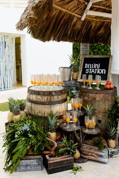 an outdoor bar with pineapples and drinks