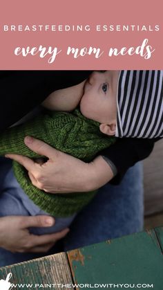 a woman holding a baby wearing a green knitted hat and black shirt with stripes on it