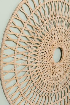 a circular rattan hanging on the wall with a hole cut out in it's center