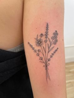 a woman's arm with flowers on it