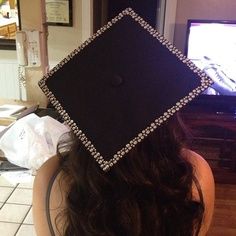 a woman wearing a graduation cap with diamonds on it