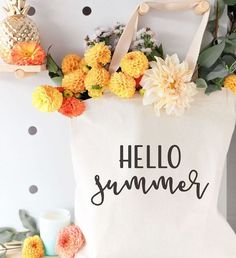 a tote bag with flowers on it sitting on top of a shelf next to a pineapple