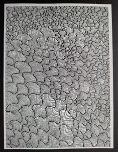 black and white drawing of wavy waves on a wall in an art gallery by person