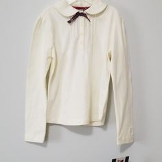 New With Tags, Tommy Hilfiger Girls Long Sleeve. With Cute Bow Detailing And 95% Cotton + 5% Acrylic It Is Sure To Keep Your Little Princess Cute And Comfy. White Collared Top For Winter, White Collared Winter Tops, Preppy Cotton Tops For Winter, Preppy Cotton Winter Tops, Tommy Hilfiger Long Sleeve Tops For Spring, White Collared Tommy Hilfiger Top, Tommy Hilfiger White Collared Top, Tommy Hilfiger White Long Sleeve Tops, White Cotton Tommy Hilfiger Tops