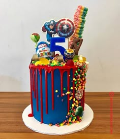 a birthday cake with the number five on top and candy sprinkles all over it