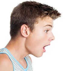 a boy making a funny face with his tongue out