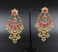 Mughal style earrings handcrafted in 22k gold, genuine untreated daimond polki slices treated ruby and fresh water pearls, Diamond slices are set with Kundan, the purest form of gold (24k). Earwires are 18k gold. Kundan-setting for gemstones is the traditional Indian style of settings. It is a unique technique that is traditional to Rajasthan and mainly practiced in Jaipur and Bikaner provinces. The process cannot be replicated with machines and is completed by three different, highly skilled craftsmen. It takes them years of dedication to learn this art. See our video to learn how these earrings were made. Though this style of jewelry is mainly made as ornate Indian bridal jewelry, we have tried to make this art form more modern. These can be worn very well with and evening gown or Indian Traditional 22k Gold Earrings With 17 Jewels, Yellow Gold Temple Jewelry Chandbalis, Gold Ruby Chandbali Bridal Earrings, Gold Chandbali Bridal Earrings With Ruby, Gold Bollywood Danglers With Ruby, Bollywood Style Gold Danglers With Ruby, Bollywood Style Bridal Earrings With Gold And Ruby, Bollywood Style Gold Ruby Danglers, 22k Yellow Gold Cutdana Earrings