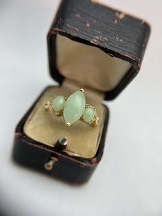 Display ring box is not included in purchase Stone: Nephrite Jade Metal: 14k yellow gold Weight: 3 grams dimensions: height 28 mm, width 23 mm, depth 15 mm Note:  stamped 14K Size 11 Can be sized by a reputable jeweler. We are new to Etsy, but our home store in Evansville, IN has been in business since 1898. We are a 5th generation family-owned business and have certificates in diamond grading from the GIA (Gemological Institute of America). All items listed in our shop are vintage or antique so imperfections can be expected but we always disclose them in the notes above. Accepted payment methods -PayPal, Visa, Mastercard, Discover, AmEx -Etsy gift card Cancelations  -Must be made within 48 hours, before your purchase is shipped.  Returns and Exchanges -We guarantee that your purchase will Classic Marquise Emerald Ring, Gold Marquise Emerald Ring In 14k Gold, Marquise Emerald Ring With Center Stone, Fine Jewelry Marquise Three-stone Ring, Fine Jewelry Marquise Three-stone Piece, Fine Jewelry With Marquise Three-stone Design, Fine Jewelry Marquise Three-stone, Fine Jewelry Marquise Three Stone, Classic Gold Marquise Emerald Ring