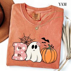 Boo Comfort Colors® T-shirt , Halloween Boo Shirt, Halloween Pumpkin Outfit, Spooky Season Tee, Ghost Clothing, Halloween Party Women Gifts ORDERING INSTRUCTIONS: -Carefully review all available photos. -Choose your desired T-shirt size from the dropdown menu. -Select your preferred T-shirt color from the available options. -Indicate the desired quantity. -Add the selected items to your cart. -Proceed to complete the checkout process. PRODUCT DETAILS: Brand: Comfort Colors Material: 100% cotton Spooky Orange T-shirt For Fall, Spooky Long-sleeve Orange T-shirt, Spooky Long Sleeve Orange T-shirt, Spooky Orange Long Sleeve T-shirt, Halloween Funny Print Orange T-shirt, Orange Funny Print T-shirt For Halloween, Orange Halloween T-shirt With Funny Print, Orange Halloween Tops With Character Print, Fun Orange Long Sleeve T-shirt