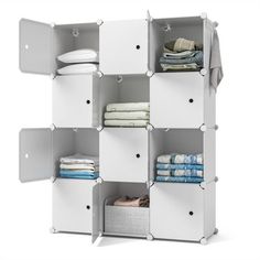 an open shelving unit with folded towels