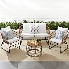 an outdoor patio with wicker furniture and pillows