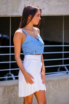 Details: Chambray crop top with bow detail and smocked back- Chambray - Bow detail - Smocked back Content: -100% Rayon Size + Fit- Model is 5'4" and wearing a Small- Measurements from a size small- Full length: 15"- Chest: 32"- Waist: 28" Trendy Crop Top With Built-in Bra For Day Out, Chic Summer Tops With Bow Tie Back, Casual Summer Tops With Bow Tie Back, Trendy Summer Tops With Bow Tie Back, Fitted Smocked Back Crop Top For Beach, Chic Cotton Crop Top, Casual Sleeveless Top With Bow Tie Back, Beach Crop Top With Smocked Back, Trendy Tie Back Crop Top For Spring