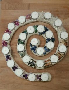 several candles are arranged in the shape of a spiral