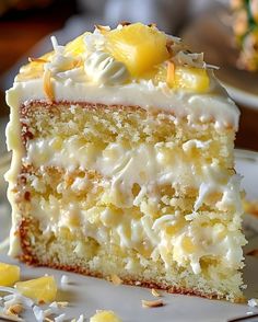 a piece of cake with white frosting and lemons on top is sitting on a plate