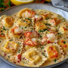 a plate of pasta with shrimp and cheese