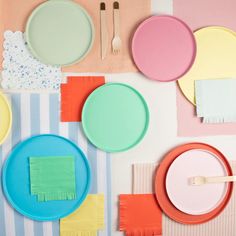 colorful plates and utensils laid out on a table