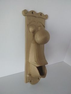 a wooden door handle with a monkey head on it's face and the handles are made out of wood