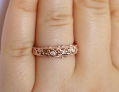 This is a truly stunning wedding ring with breathtaking delicate pattern details. This beauty has a rustic inspiration of leaf filigree mixed with vintage Edwardian feminine style. Absolutely breathtaking and ideal for everyday wear. You are going to fall in love with it from the minute you put this marvelous art on your finger. 14k Rose Solid Gold 3 Natural Diamonds G-H Color/ VS Clarity Weight: .04 approximately 2 Natural Emeralds Weight: .02 carat approximately Proudly made in USA. Ethical So Elegant Wedding Ring With Rose Cut Diamonds, Elegant Rose Cut Diamond Wedding Ring, Elegant Filigree Ring With Intricate Design For Marriage, Rose Gold Filigree Wedding Jewelry, Rose Gold Filigree Jewelry For Wedding, Elegant Wedding Single Cut Diamonds Jewelry, Heirloom Wedding Jewelry With Elegant Design, Wedding Diamond Jewelry With Intricate Design, Dainty Filigree Jewelry For Wedding