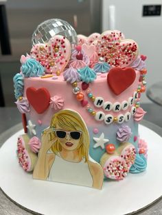 a birthday cake decorated with an image of a woman's face and sunglasses on top