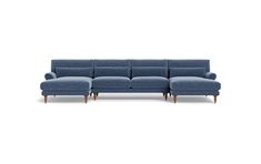 a blue sectional couch with wooden legs and arm rests in front of a white background