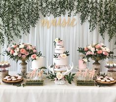 a table topped with lots of cakes and cupcakes