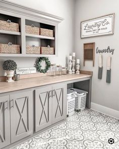 a white and gray laundry room with lots of storage