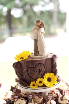 a wedding cake decorated with sunflowers and chocolate