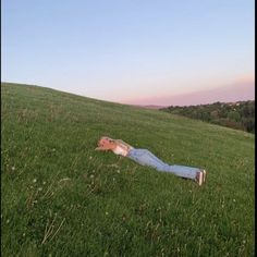 a man laying on the ground in a field