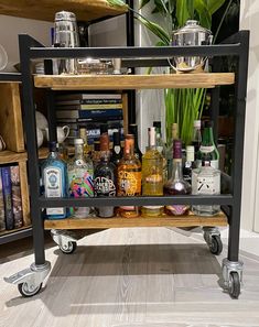 a bar cart filled with liquor bottles and glasses