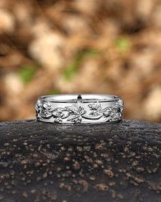 a wedding ring sitting on top of a rock