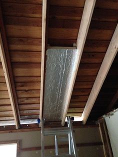 a ladder is attached to the ceiling in an unfinished room