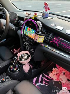 the interior of a car is decorated with various items such as an ipod and other gadgets