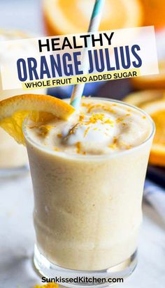 an orange juice smoothie in a glass with a straw