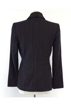 Size 4 Black Pinstripe Blazer Shell 67% wool 29% viscose 3% spandex 1% polyester Lining 100% polyester Padded shoulders Single front button close 2 front decorative flapover pockets White & black polka dot lining Shoulder to shoulder 15" Shoulder to hem 26" Elegant Striped Outerwear For Office, Fitted Striped Wool Outerwear, Classic Striped Outerwear For Office Wear, Fitted Fall Outerwear With Vertical Stripes, Classic Fitted Striped Outerwear, Fitted Blazer With Vertical Stripes And Long Sleeves, Fitted Long Sleeve Blazer With Vertical Stripes, Formal Fitted Striped Outerwear, Striped Fitted Outerwear With Notch Lapel