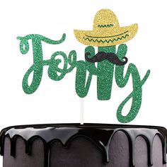 a cake topped with a green frosting and a topper that says fiesta on it