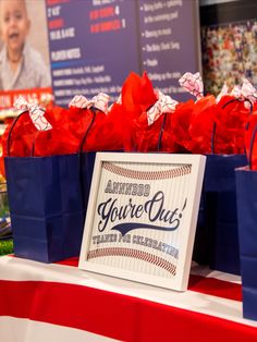 some bags that are on a table with red, white and blue wrapping around them