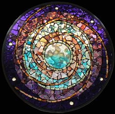 a circular stained glass window with metal studs