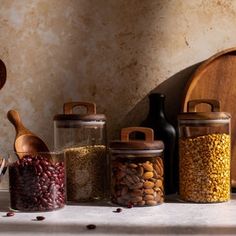 an assortment of beans and nuts in glass jars