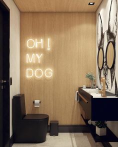 a bathroom with a toilet, sink and mirror on the wall that says oh my dog