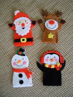 four felt christmas decorations are on the floor, one has a snowman and two is a reindeer