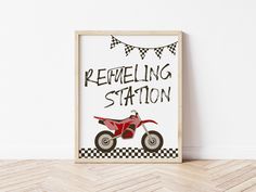 a red dirt bike sitting on top of a wooden floor next to a white wall