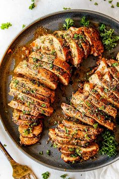 grilled pork chops in a pan with parsley on the side, ready to be served