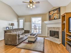 a living room filled with furniture and a flat screen tv on top of a hard wood floor