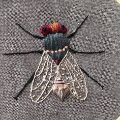 a close up of a piece of cloth with a bug on it's back