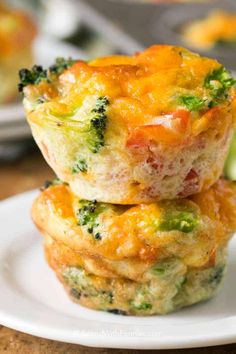 broccoli and cheese muffins stacked on top of each other in a white plate