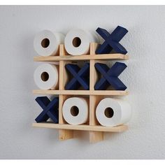 several rolls of toilet paper are stacked on a wooden rack with two rows of them